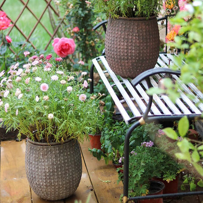 StoneNest Textured Planters, brown woven pots on a deck with flowers, two planters on Tampa Home & Garden Store