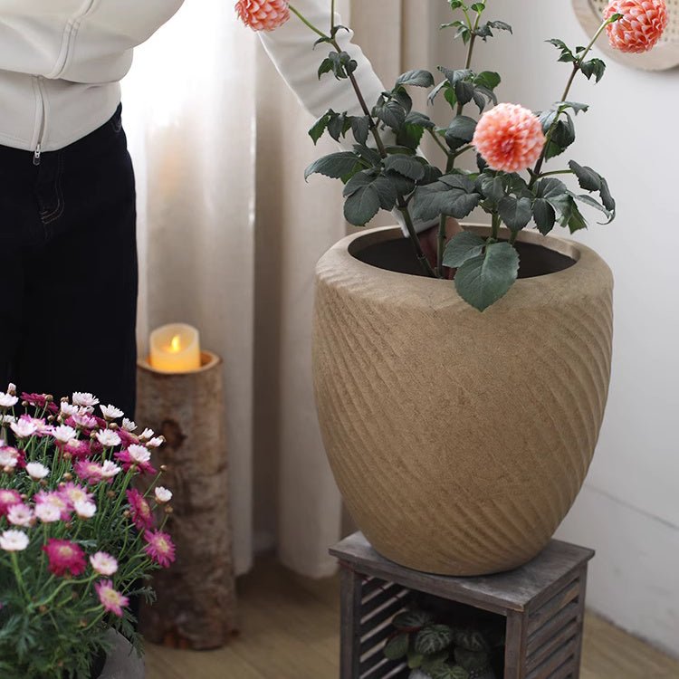 Comtemporary Swirl Planter RusticReach beige ceramic with plant blooms on wooden stand on Tampa Home & Garden Store