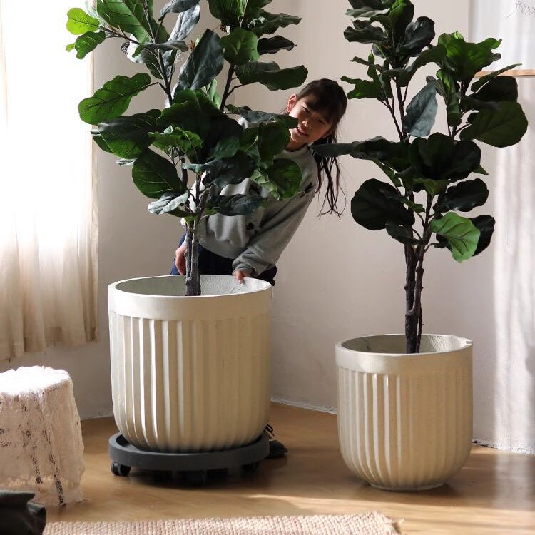 Nordic Vertical Stripe Flower Pot set with two beige ribbed planters and tall leaves on Tampa Home & Garden Store