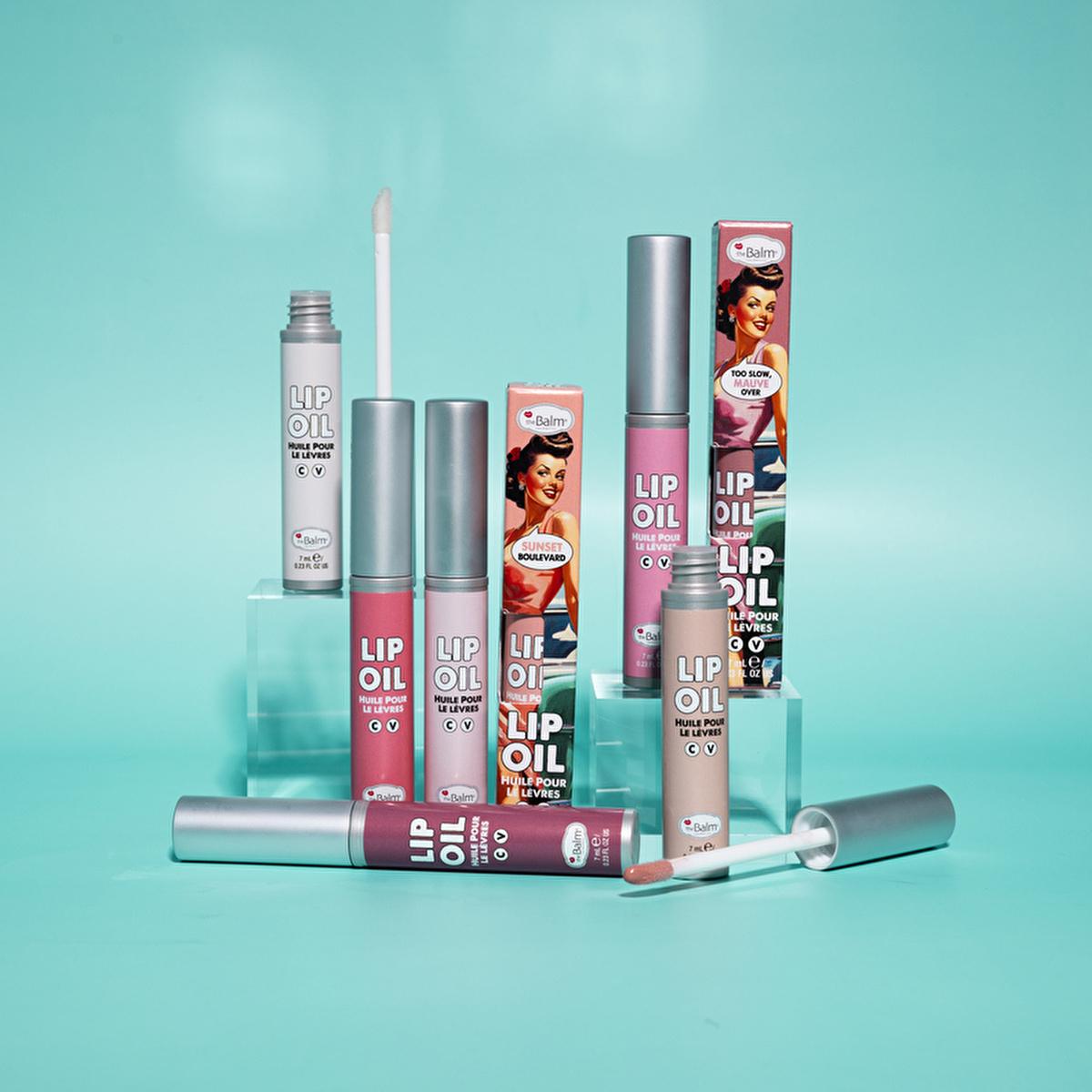 theBalm Take The High Rose Lip Oil lip gloss set in pastel pink on teal backdrop on Tampa Home & Garden Store