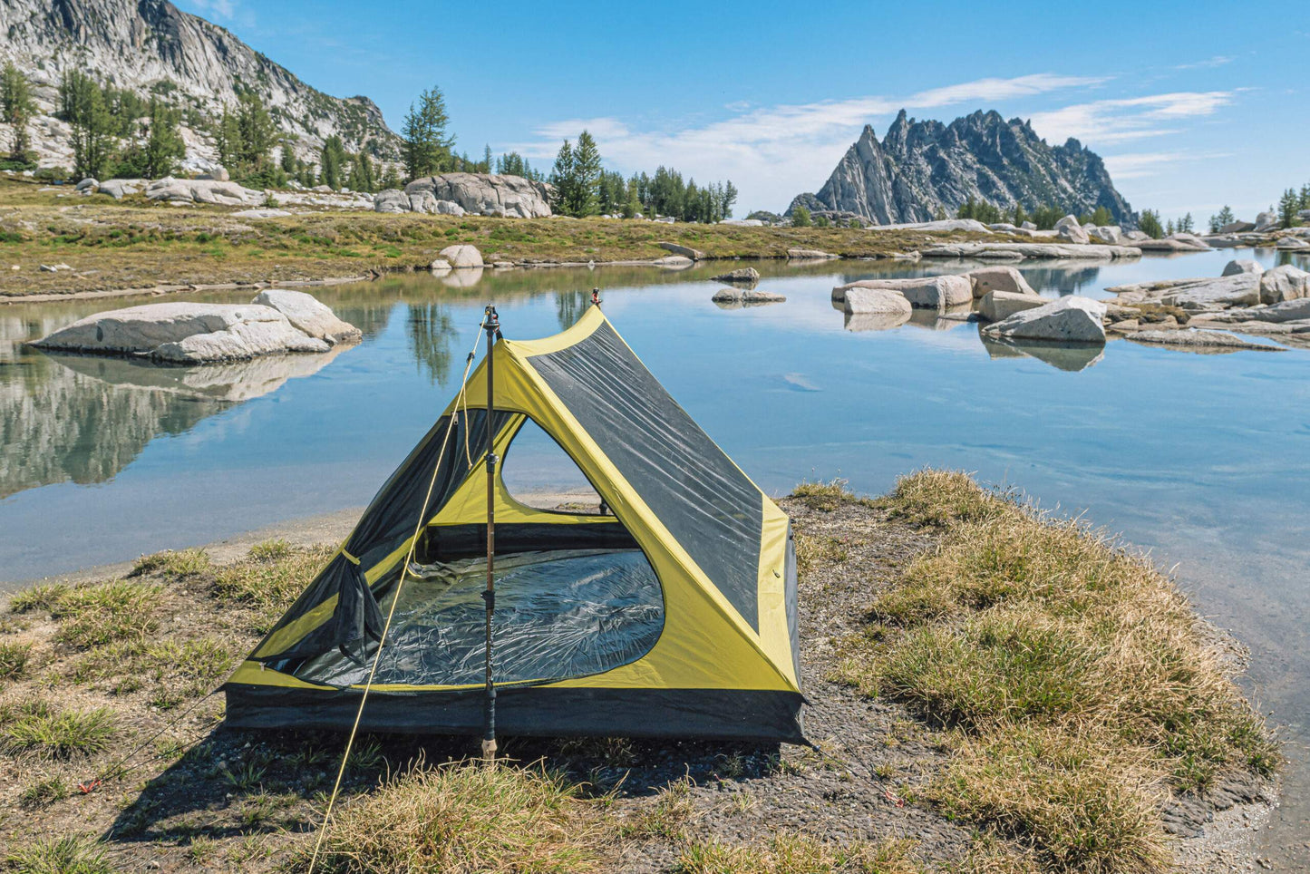 Trekker Palace 2-Person Backpacking Tent by River Country Gear, yellow and black pitched beside a lake on Tampa Home & Garden Store
