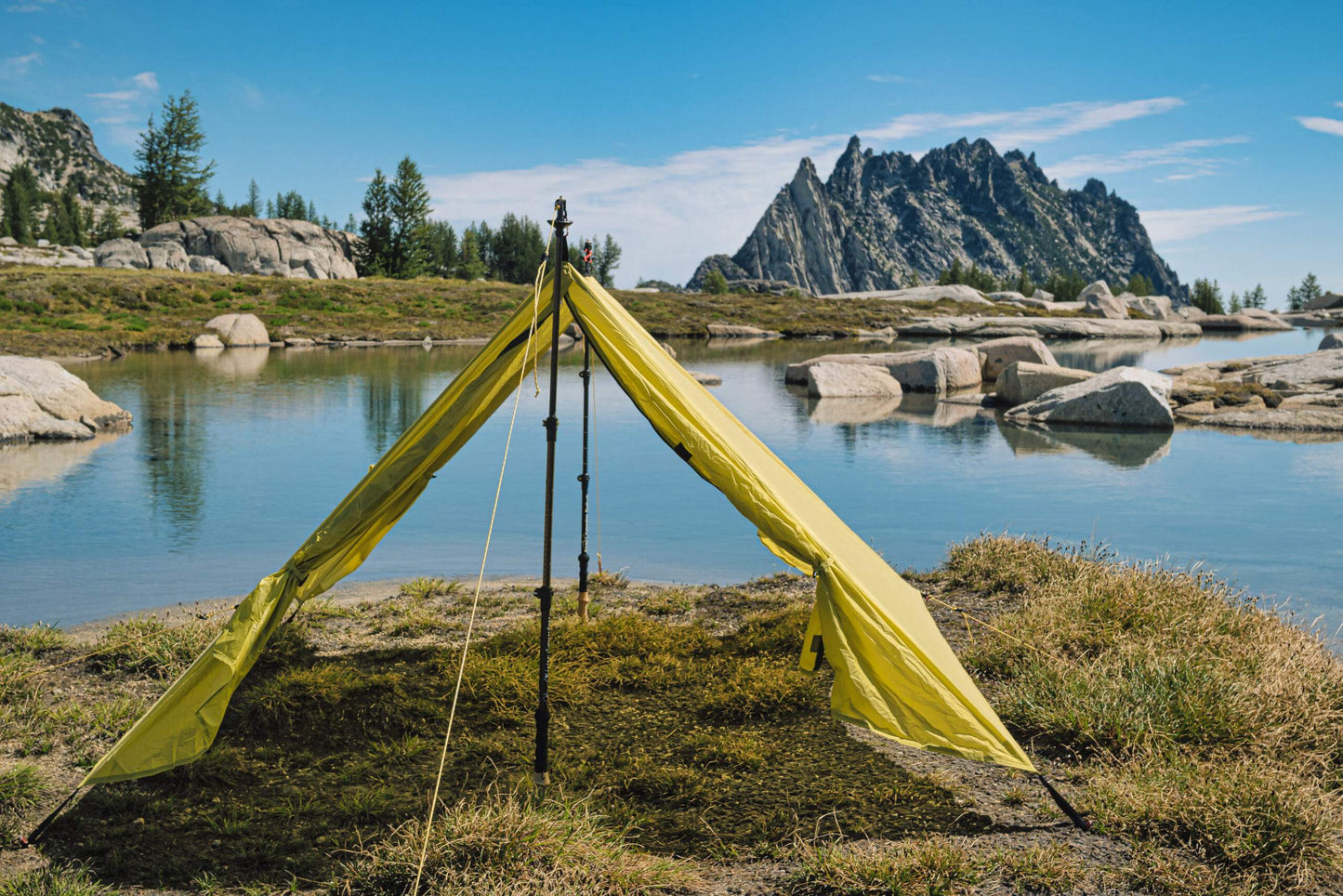 Trekker Palace 2-Person Backpacking Tent bright yellow pitched by lake with rocky cliffs on Tampa Home & Garden Store