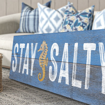 Stay Salty coastal sign on blue distressed wood with white lettering and gold seahorse on Tampa Home & Garden Store