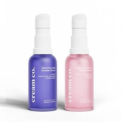 Cream Co. face serum duo: blue AHA Complex and pink Hyaluronic Serum bottles with spray tops on Tampa Home & Garden Store