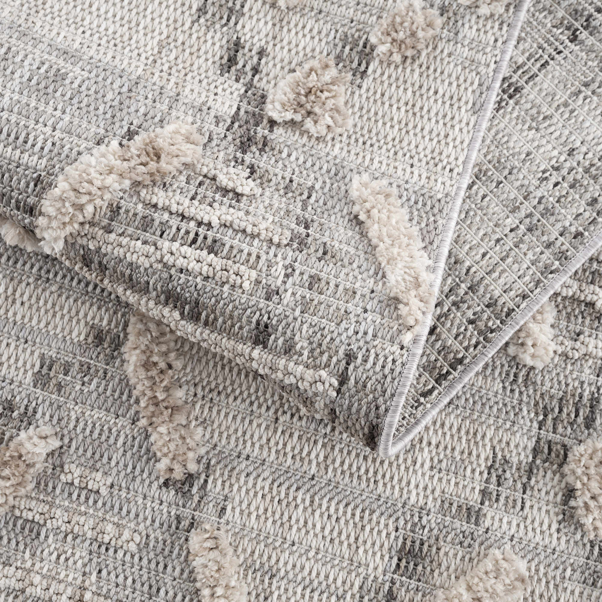 Bogtong High-Low Rustic Rug by Boutique Rugs, gray ivory textured rug with pompom accents on Tampa Home & Garden Store