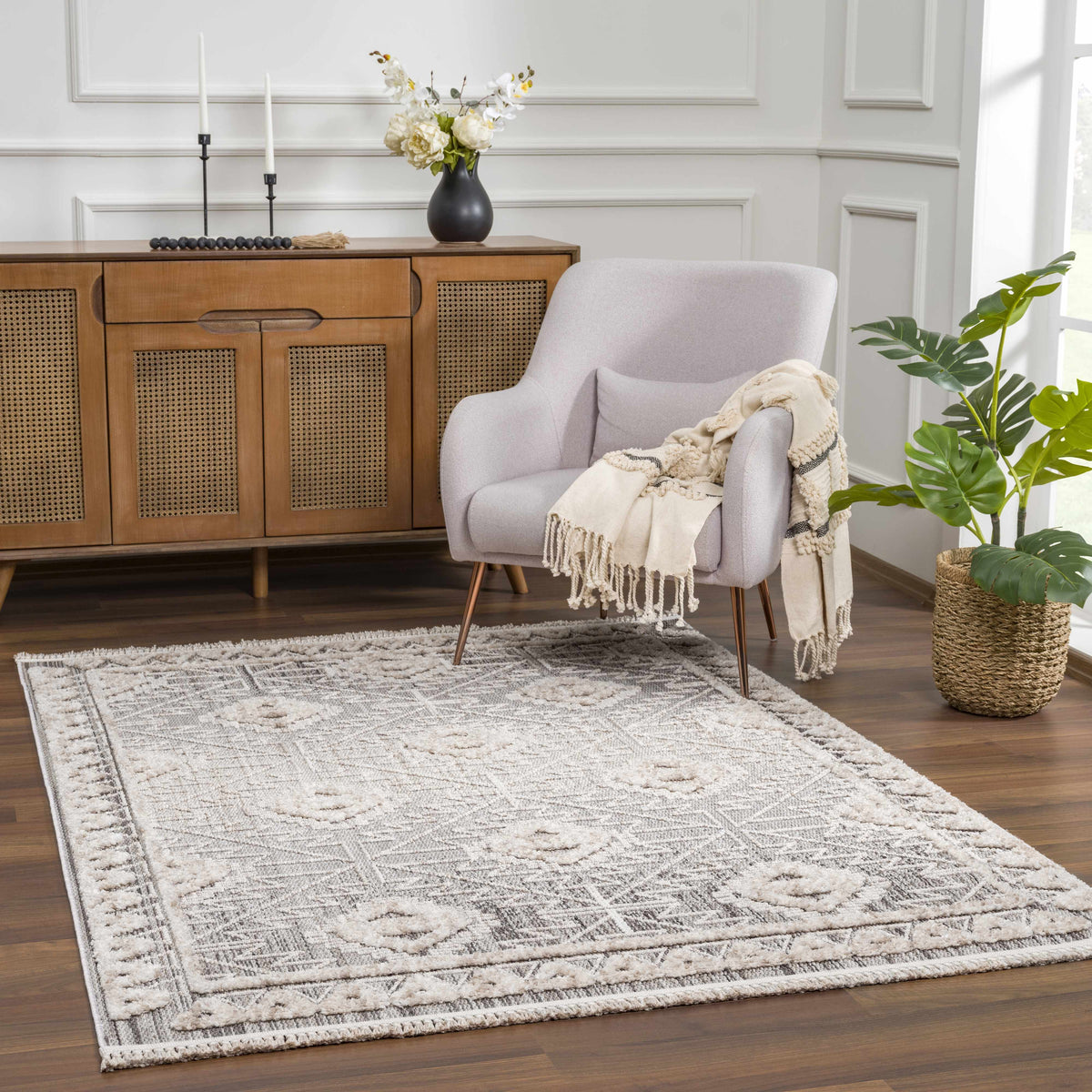 Agoo High-Low Pile Rustic Rug Boutique Rugs, cream with subtle border in a cozy living room on Tampa Home & Garden Store