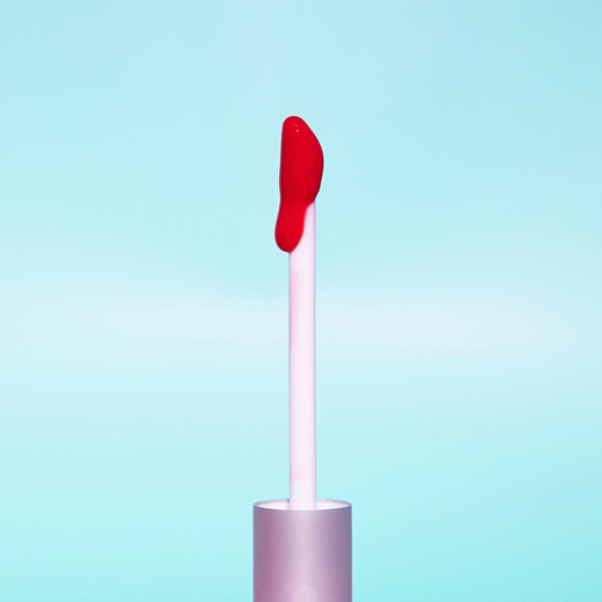 theBalm Little Red Corvette Lip Oil lip gloss wand with red gloss on white applicator on Tampa Home & Garden Store