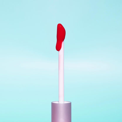 theBalm Little Red Corvette Lip Oil lip gloss wand with red gloss on white applicator on Tampa Home & Garden Store