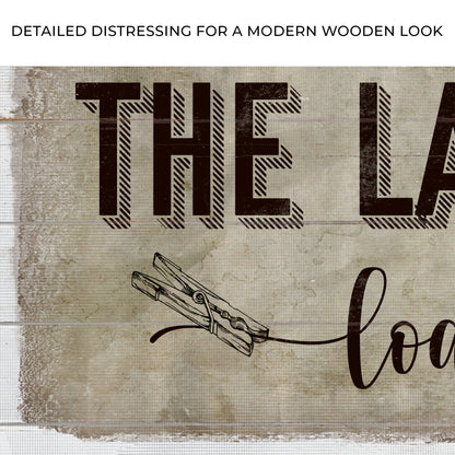 Canvas sign Loads of Fun with distressed wood backdrop and bold textured laundry lettering on Tampa Home & Garden Store