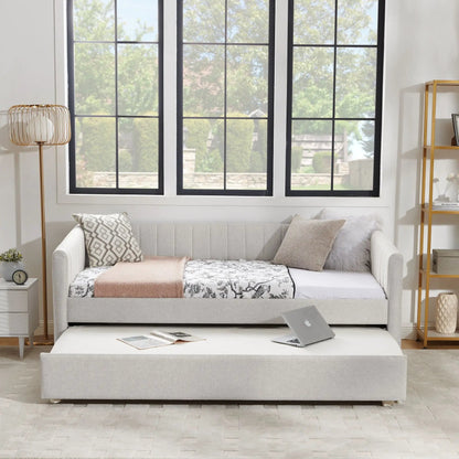 Upholstered gray daybed with pull-out trundle, featuring patterned pillows and a soft throw on Tampa Home & Garden Store