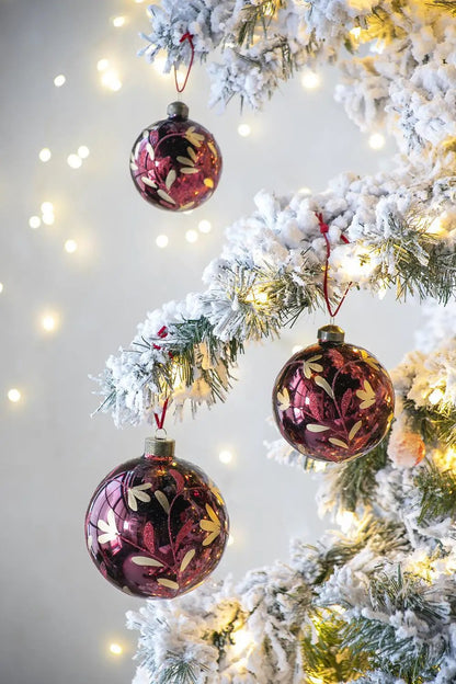Glass burgundy Christmas ball ornament set of 3 with gold leaf pattern on a snow-dusted tree on Tampa Home & Garden Store