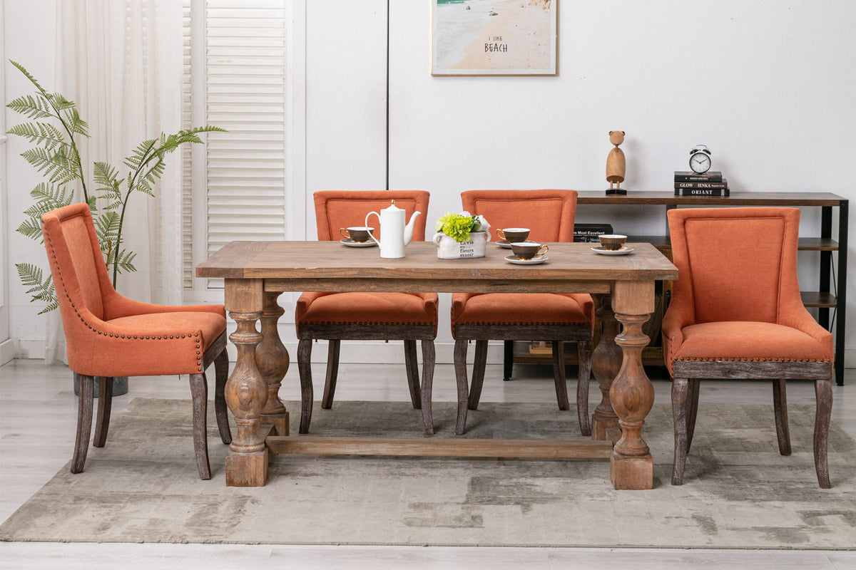 Ultra Side Dining Chair, Nail Head orange upholstery with dark wood legs at a wood dining table on Tampa Home & Garden Store