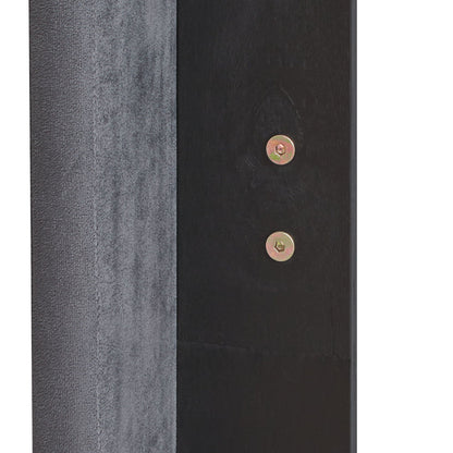 Queen platform bed panel in gray upholstery beside black wood with visible brass bolts on Tampa Home & Garden Store