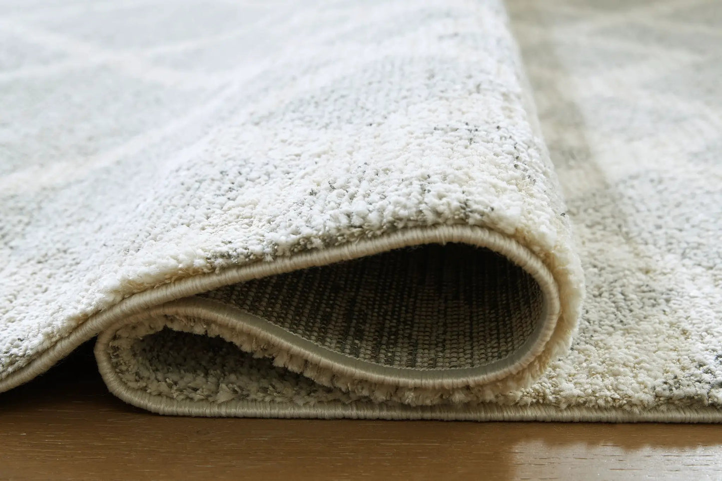 Unawick Rug cream shag pile with rolled edge by Unique Piece Furniture on Tampa Home & Garden Store