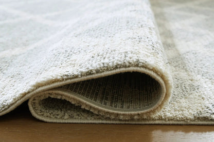 Unawick Rug cream shag pile with rolled edge by Unique Piece Furniture on Tampa Home & Garden Store
