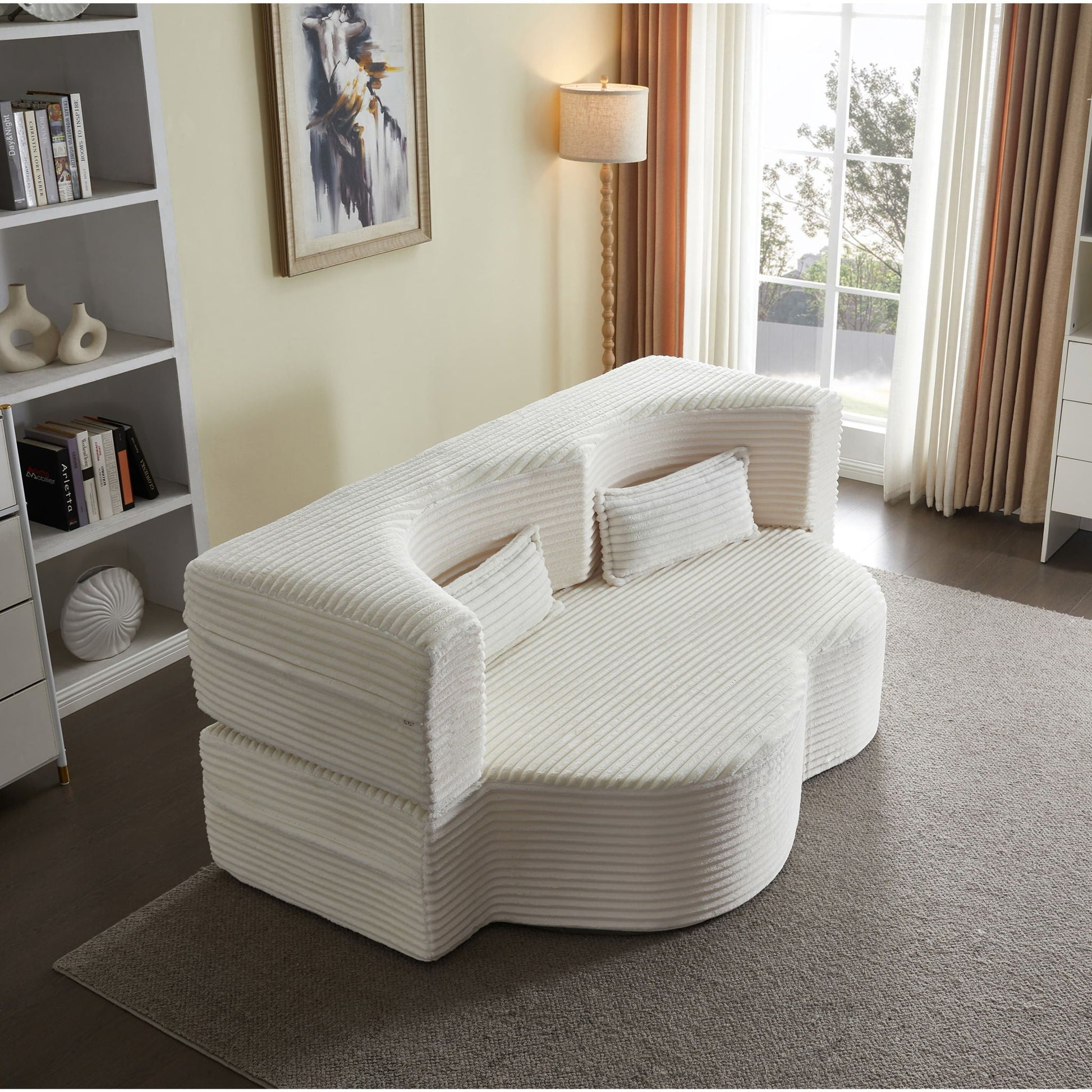 Floor convertible sleeper sofa bed in white ribbed upholstery with 2 pillows in living room on Tampa Home & Garden Store