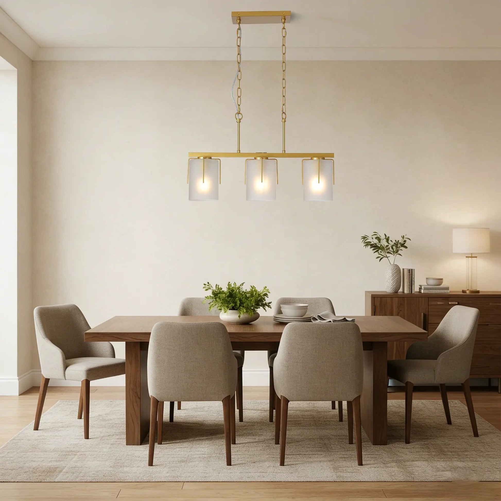 Adjustable brass cylindrical pendant light with frosted glass shades over dining table on Tampa Home & Garden Store