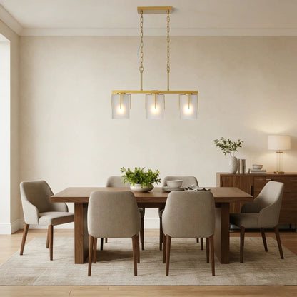 Adjustable brass cylindrical pendant light with frosted glass shades over dining table on Tampa Home & Garden Store