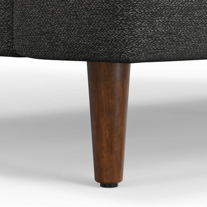 Livingston upholstered sofa close-up: dark textured fabric with a brown wooden leg on Tampa Home & Garden Store