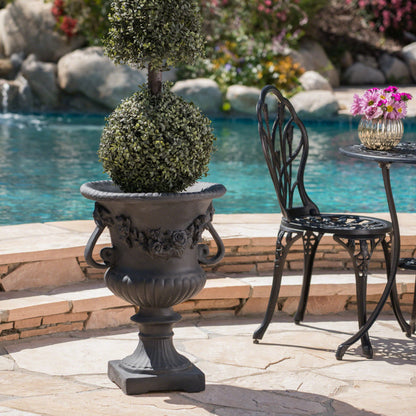 Buena Vista Urn planter with ornate black finish and lush topiary ball by pool on Tampa Home & Garden Store