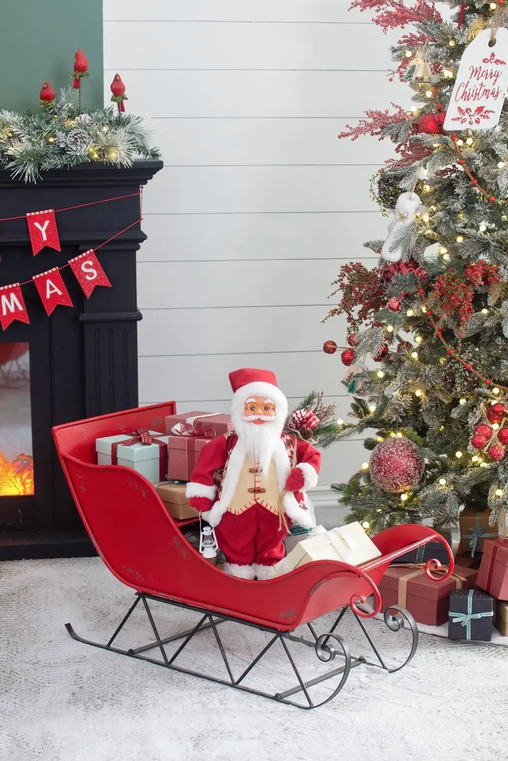 Iron Sleigh Distressed red Christmas decoration with Santa and gifts indoors on Tampa Home & Garden Store