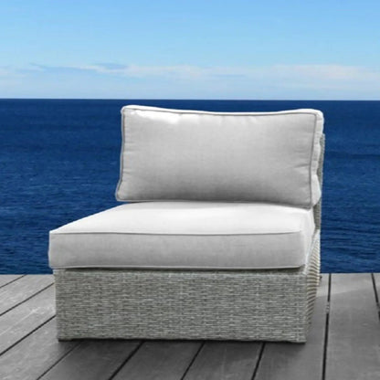 Armless patio chair with light gray cushions, woven gray wicker base on a seaside deck on Tampa Home & Garden Store