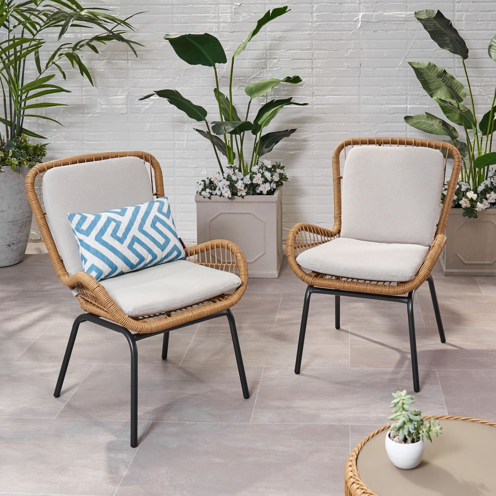 Outdoor wicker club chairs with beige cushions and a blue chevron pillow set of 2 on Tampa Home & Garden Store