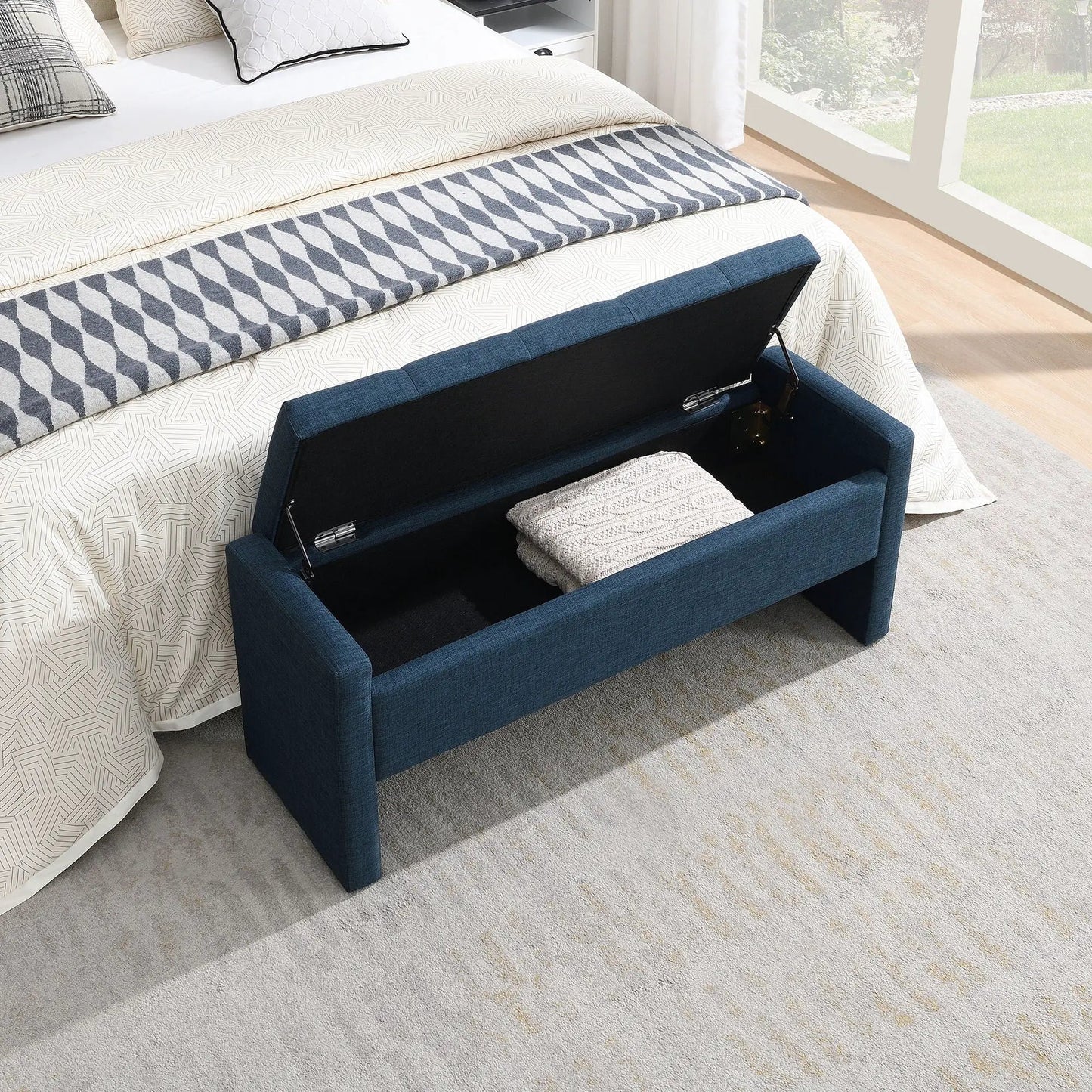 Modern upholstered bed end bench with storage in deep blue fabric at foot of bed on Tampa Home & Garden Store