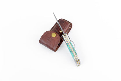 AzureGlide Tanto knife with turquoise resin handle and Damascus blade in a brown leather sheath on Tampa Home & Garden Store