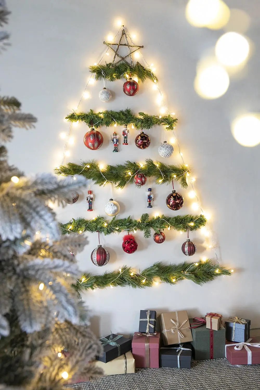 Christmas hanging ball tree by Unique Piece Furniture with greenery, warm lights and star topper on Tampa Home & Garden Store