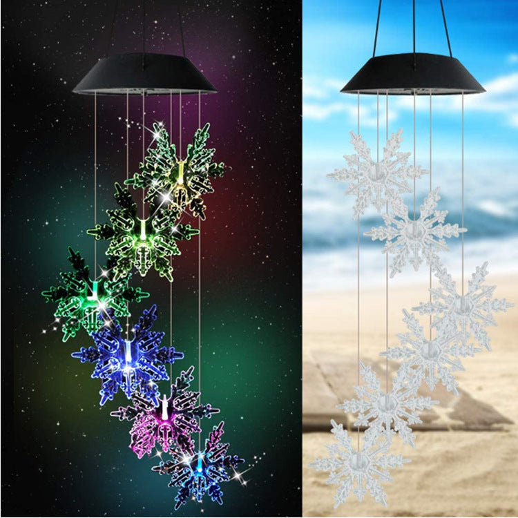 Outdoor solar wind chime lamp with hanging snowflake ball pendants; multicolor glow at night on Tampa Home & Garden Store