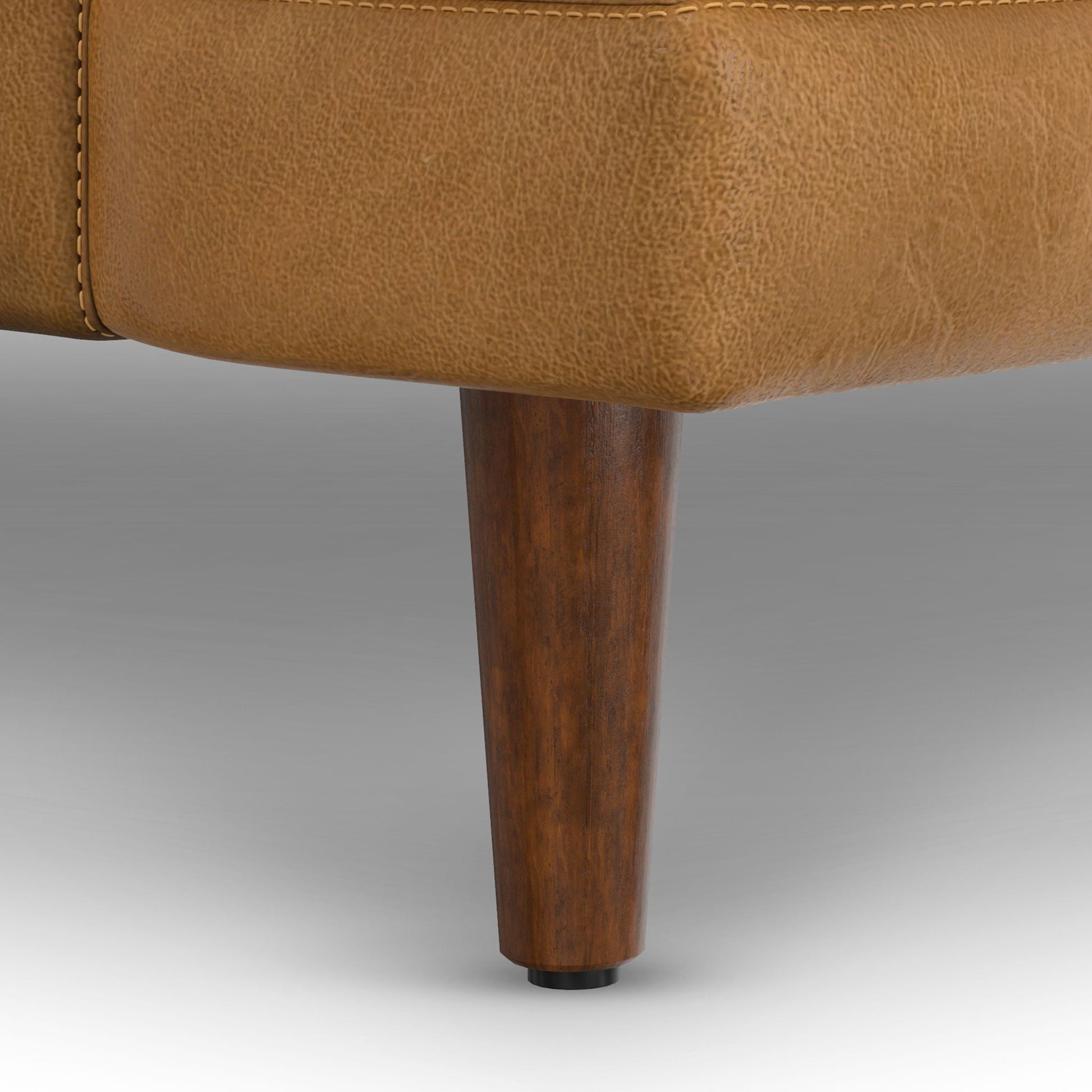 Livingston upholstered sofa bottom edge in tan textured fabric with dark wooden leg on Tampa Home & Garden Store