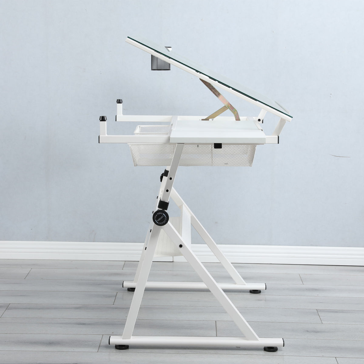 White adjustable tempered-glass drafting table with metal frame and mesh storage shelf on Tampa Home & Garden Store