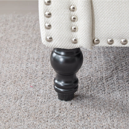 Beige fabric accent chair with nailhead trim and black turned leg on Tampa Home & Garden Store