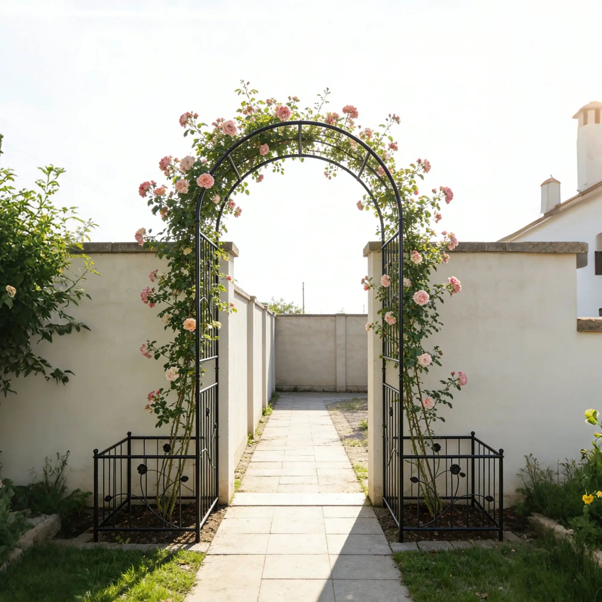 Metal garden arch with two plant stands in black supporting climbing roses along a path on Tampa Home & Garden Store