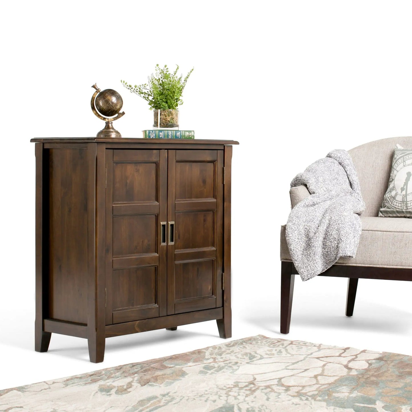 Burlington Handcrafted Low Storage Cabinet in dark wood; globe, plant in glass vase, and books on Tampa Home & Garden Store