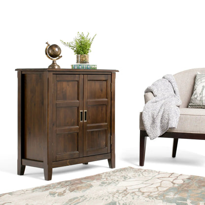 Burlington Handcrafted Low Storage Cabinet in dark wood; globe, plant in glass vase, and books on Tampa Home & Garden Store