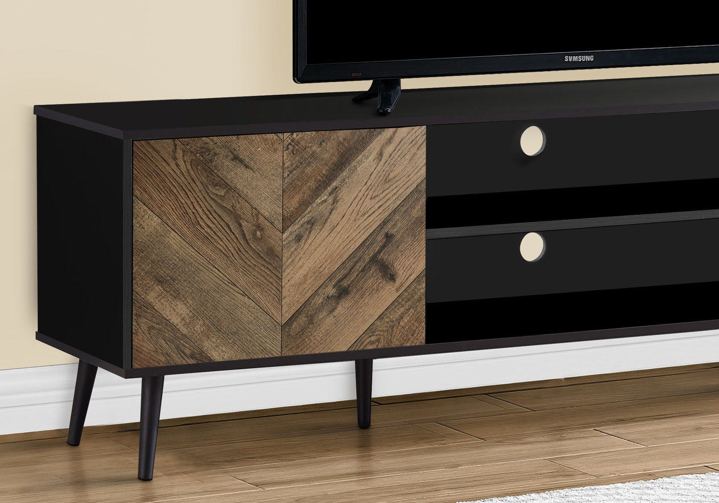 TV stand console in black with woodgrain chevron doors and black drawers, tapered legs, Samsung TV on Tampa Home & Garden Store