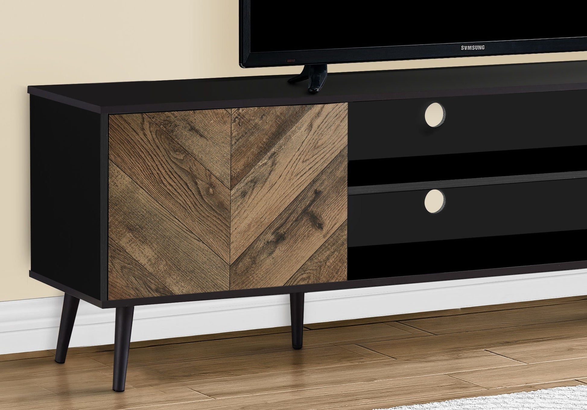 TV stand console in black with woodgrain chevron doors and black drawers, tapered legs, Samsung TV on Tampa Home & Garden Store