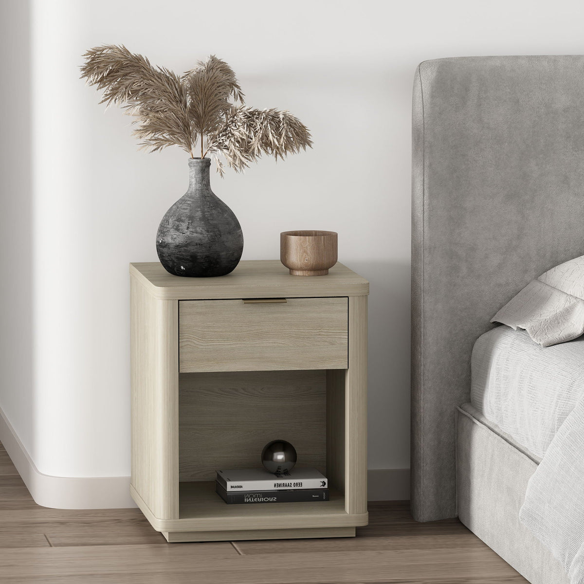 Evelyn Nightstand with 1 drawer and open shelf in light oak finish beside a grey bed on Tampa Home & Garden Store