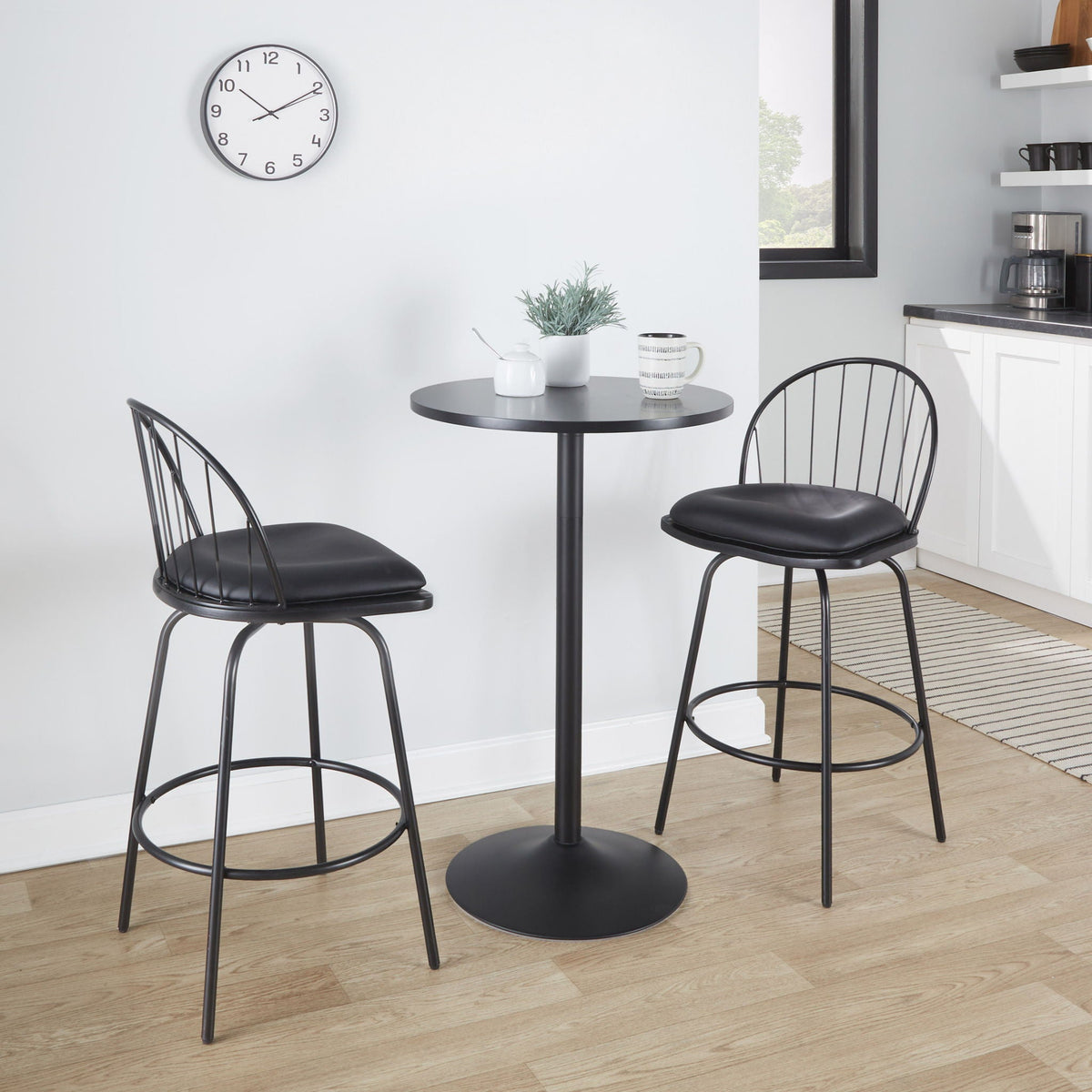 Farmhouse counter stool set with swivel and round footrests in black around pedestal table on Tampa Home & Garden Store