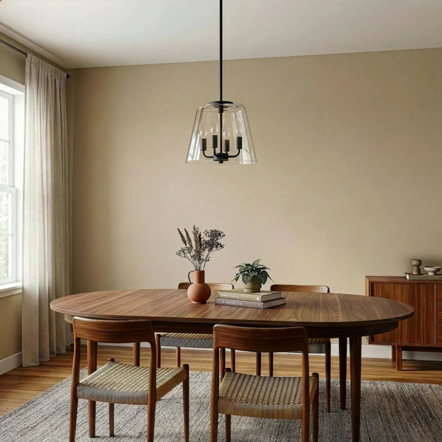 Soiree 4-Candle Lights Pendant in black metal with glass shade over round wood dining table on Tampa Home & Garden Store