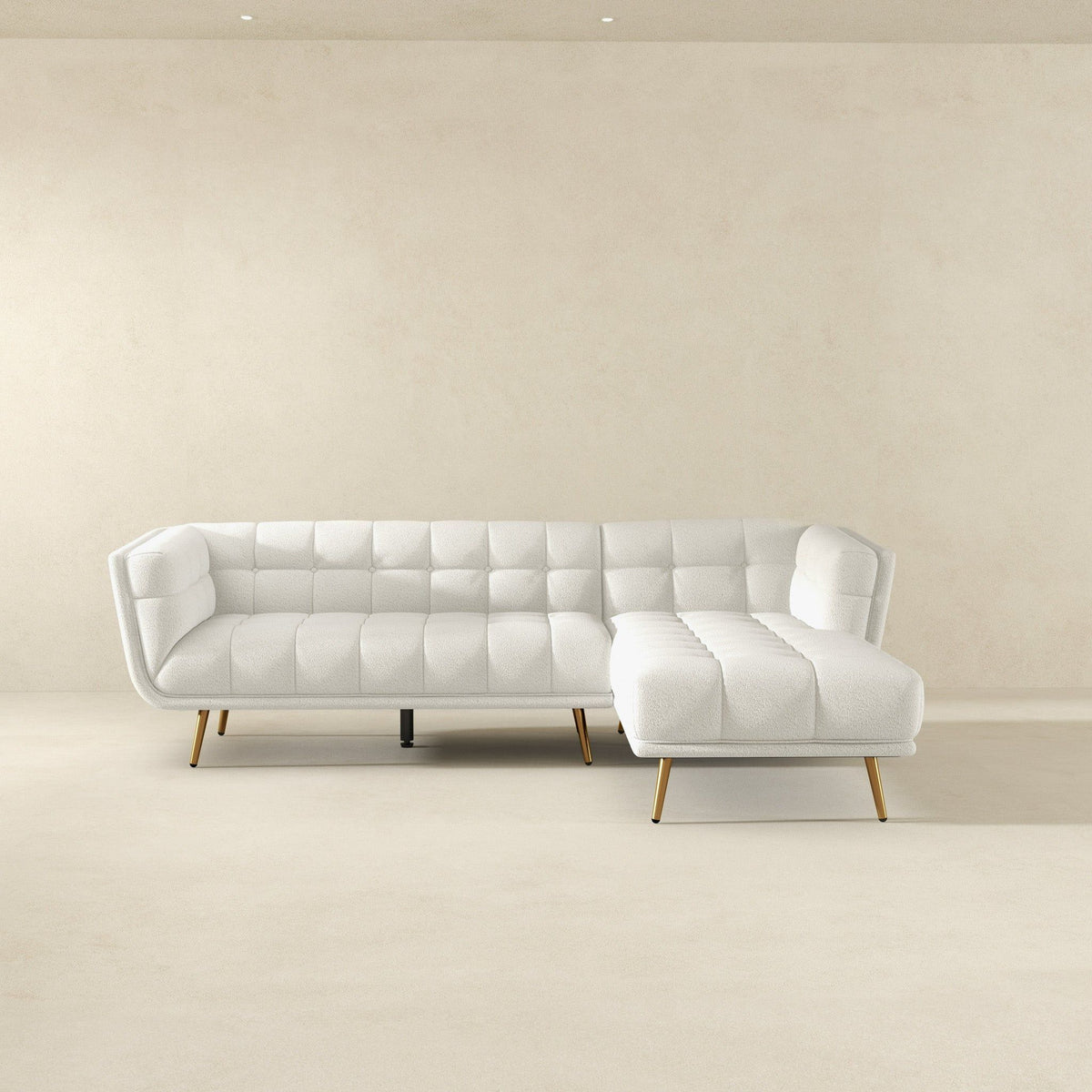 White L-shaped tufted sectional sofa with mid-century modern design and gold legs on Tampa Home & Garden Store