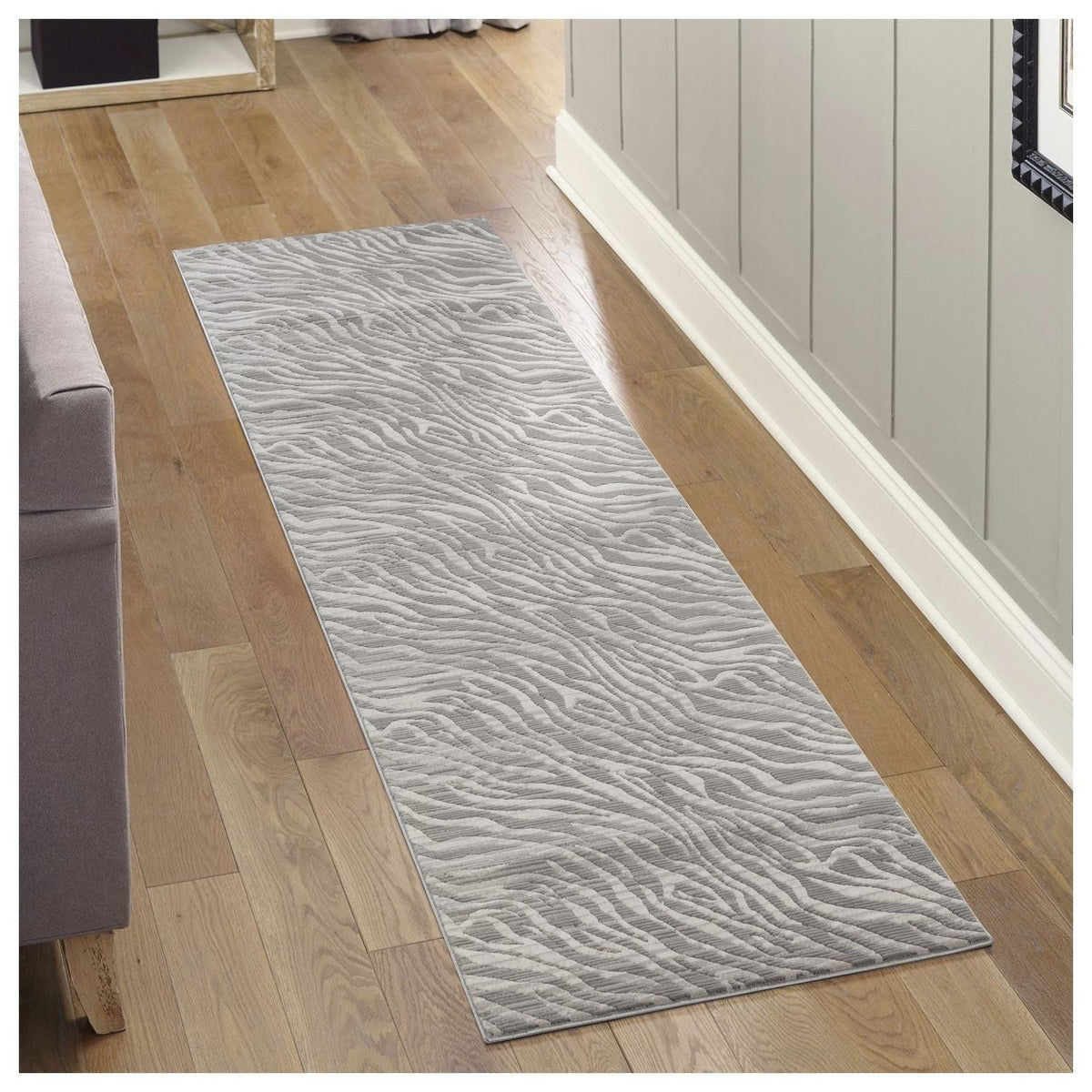 Gray geometric area rug runner with waved pattern and ultra-soft fibers on hardwood floor on Tampa Home & Garden Store