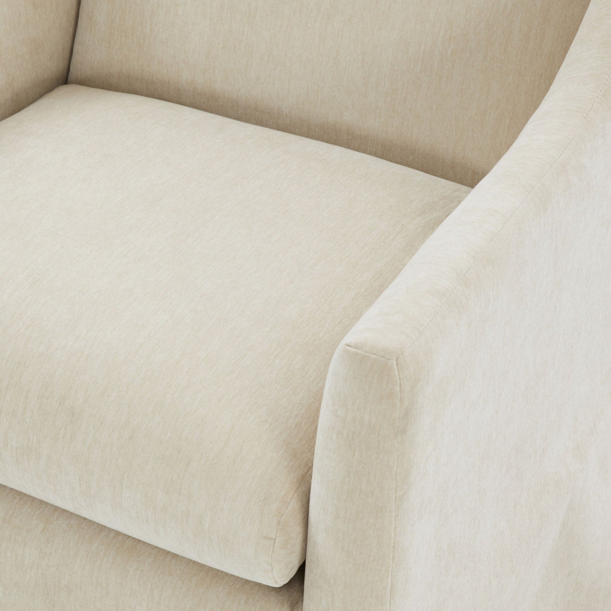 Skirted swivel accent chair beige upholstery with curved arm close-up on Tampa Home & Garden Store