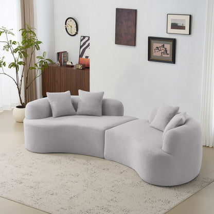 Curved 4-seater sofa in soft gray fabric with plush cushions in a modern living room on Tampa Home & Garden Store