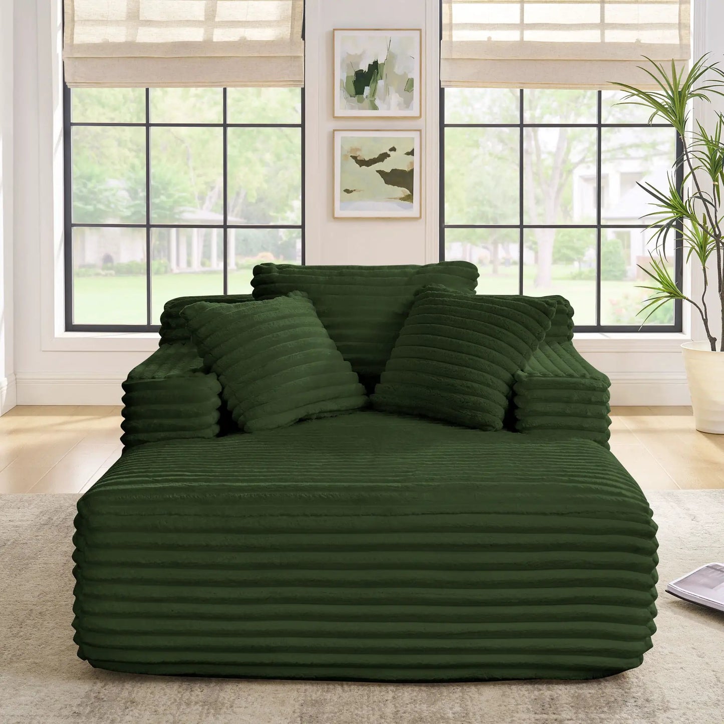 Chaise lounge sofa bed with deep green ribbed cushions stacked in a bright living room on Tampa Home & Garden Store