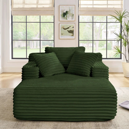 Chaise lounge sofa bed with deep green ribbed cushions stacked in a bright living room on Tampa Home & Garden Store