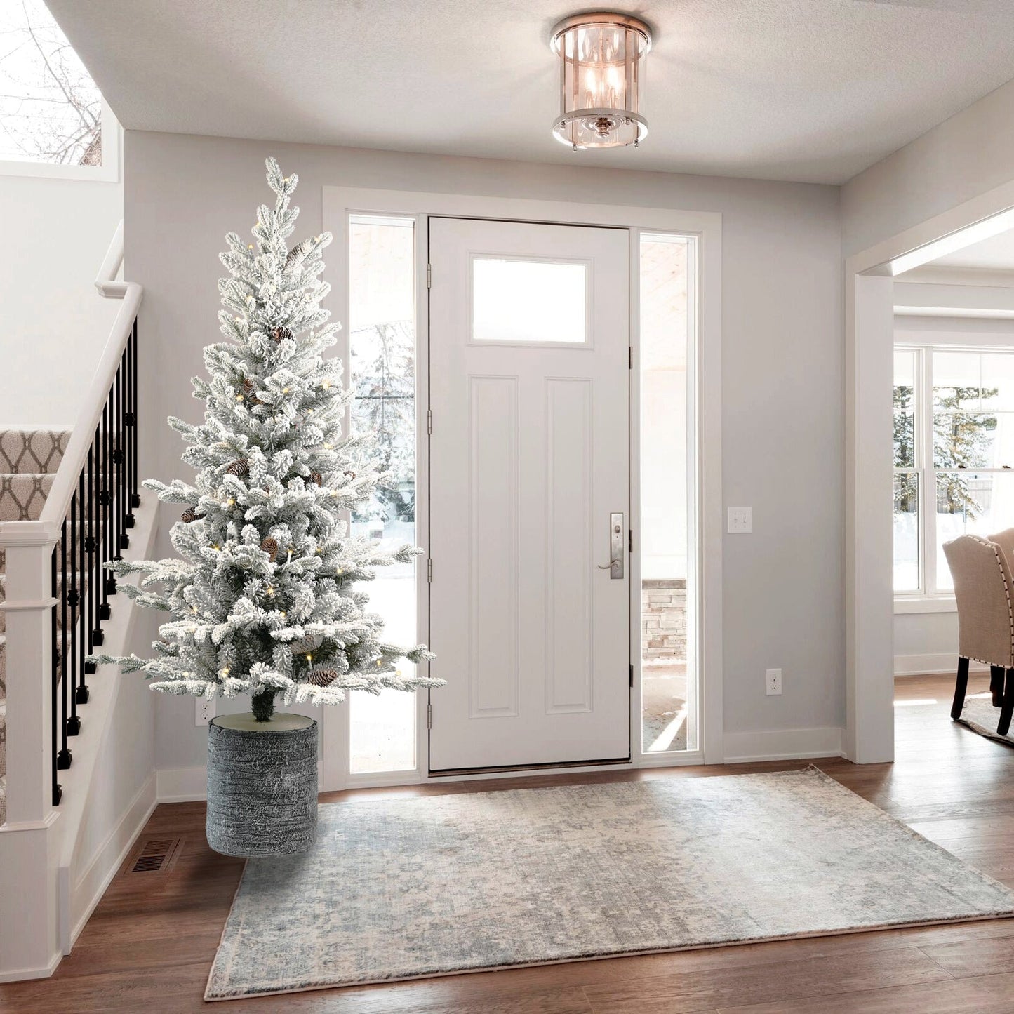 2ft flocked Christmas tree with pot base by HouseOfZazla in a foyer with pinecones and lights on Tampa Home & Garden Store