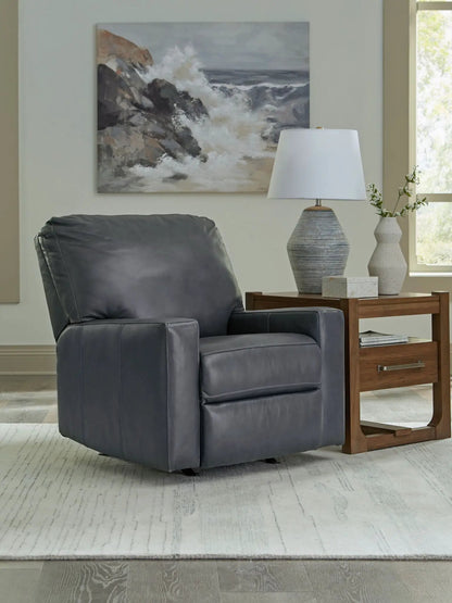 Bolsena rocker recliner in dark gray leather with cushioned arms beside a wood end table on Tampa Home & Garden Store